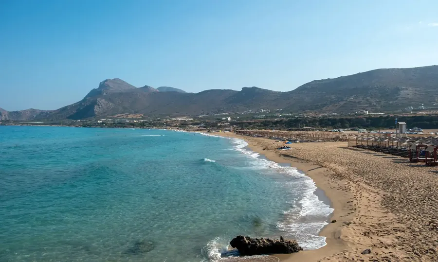 Falasarna beach on Crete with turquoise water and umbrellas on white sand