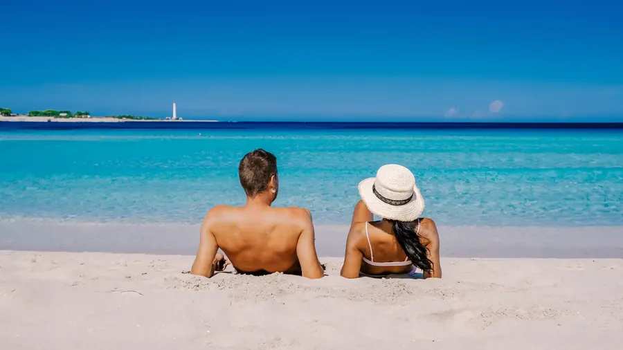 San Vito Lo Capo beach with white sand, turquoise water and Monte Monaco behind