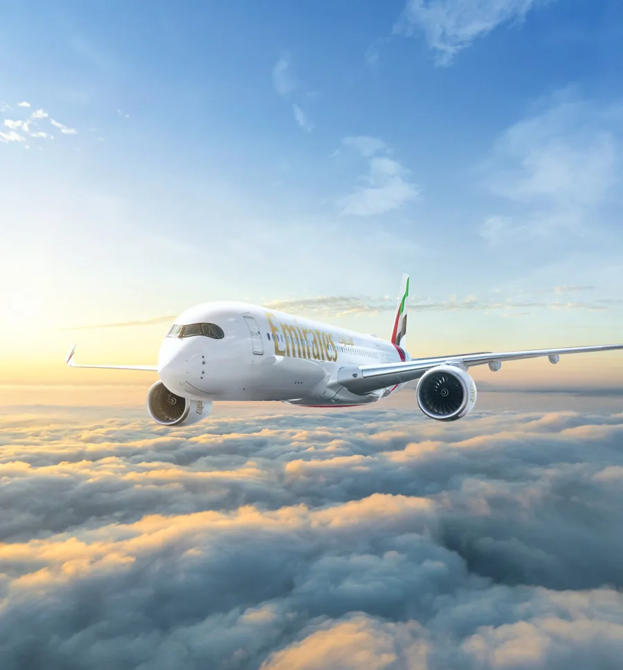 Emirates Airbus A350 in flight above the clouds