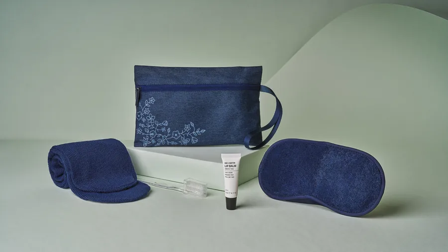 Singapore Airlines Premium Economy amenity kit with batik motif and INK & WATER lip balm
