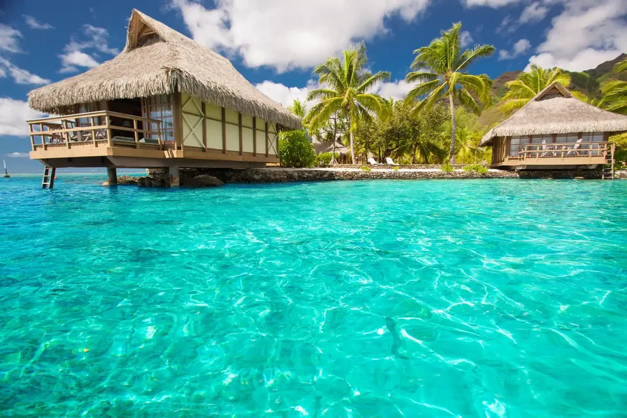 Overwater bungalows with steps into a blue lagoon